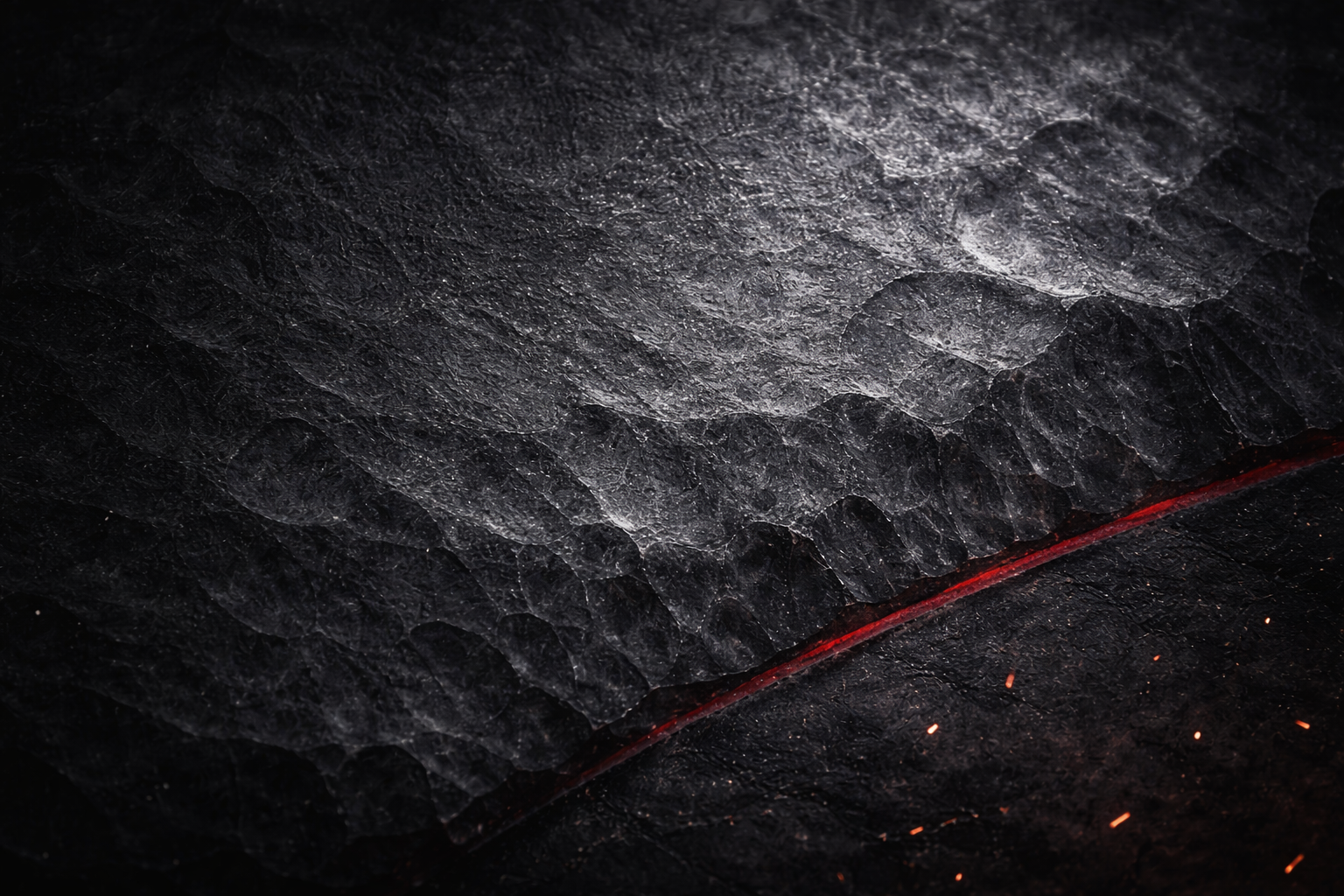 Handcrafted knife on dark workbench